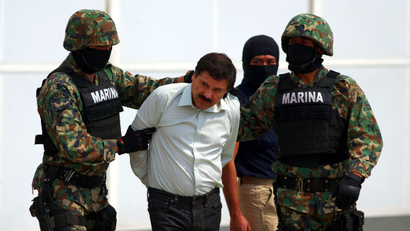 Joaquin "El Chapo" Guzman is escorted to a helicopter in handcuffs by Mexican navy marines at a navy hanger in Mexico City, Mexico, Saturday, Feb. 22, 2014. A senior U.S. law enforcement official said Saturday, that Guzman, the head of Mexico’s Sinaloa Cartel, was captured alive overnight in the beach resort town of Mazatlan. Guzman faces multiple federal drug trafficking indictments in the U.S. and is on the Drug Enforcement Administration’s most-wanted list.