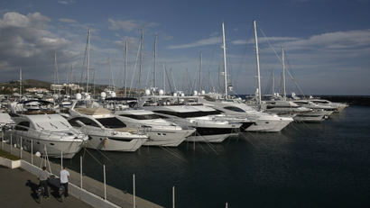 Cyclists look at boats in a marina near Limassol, a coastal town in southern Cyprus.