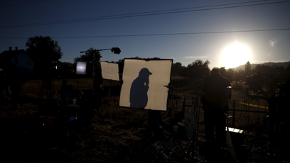 Television crews film at sunrise outside Umpqua Community College in Roseburg