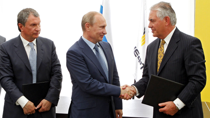 Russian President Vladimir Putin, center, and Exxon Mobil Corp. CEO Rex Tillerson shake hands at a signing ceremony of an agreement between state-controlled Russian oil company Rosneft and Exxon Mobil corporation at the Black Sea port of Tuapse, southern Russia, Friday, June 15, 2012. At left is CEO of state-controlled Russian oil company Rosneft Igor Sechin