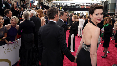 Anne Hathaway, right, and Adam Shulman arrive at the Oscars on Sunday, March 2, 2014, at the Dolby Theatre in Los Angeles.