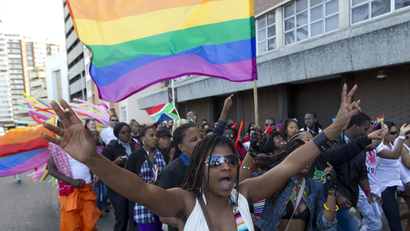 A woman holds her hands up during the Durban Pride parade where several hundred people marched through the Durban city centre in support of gay rights, July 30, 2011.