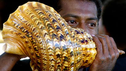A Fijian man blows a sea-shell as part of the mourning for the late former President of Fiji Ratu Sir Kamisese Kapaiwai Tuimacilai Mara at Government House in Suva April 29, 2004. The shells are part of the traditional mourning process, and have been playing since Mara died on April 18, and will continue until he is buried on May 3. Mara, who was prime minister for 22 years and later Fiji's president, died aged 83 and is continuing to lie in state in Government House for political leaders and members of the public to pay their respects.