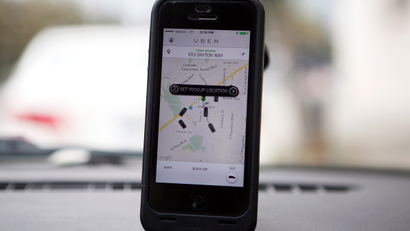 An Uber app is seen on an iPhone in Beverly Hills, California, December 19, 2013. Uber has entered more than 60 markets, ranging from its hometown of San Francisco to Berlin to Tokyo. Leaked financials in December indicate that the company, which began connecting passengers with drivers of vehicles for hire about 3-1/2 years ago, is generating $200 million a year in revenue beyond what it pays to drivers. Photo taken December 19, 2013.