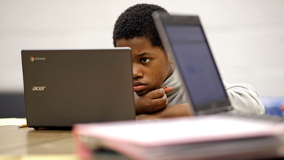In this Feb. 12, 2015 photo, Marquez Allen, age 12, reads test questions on a laptop computer during in a trial run of a new state assessment test at Annapolis Middle School in Annapolis, Md. The new test, which is scheduled to go into use March 2, 2015, is linked to the Common Core standards, which Maryland adopted in 2010 under the federal No Child Left Behind law, and serves as criteria for students in math and reading
