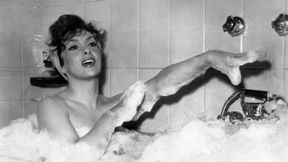 Italian actress Gina Lollobrigida takes a bubble bath in a scene of her new film called "Anna from Brooklyn"