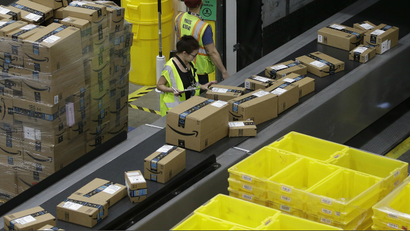 People working in an Amazon warehouse.