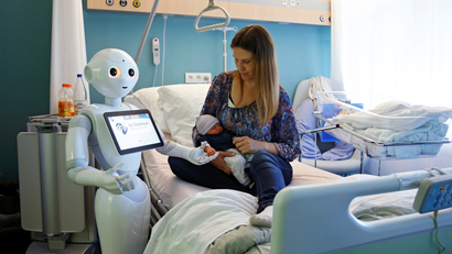 A robot helps look after a newborn baby