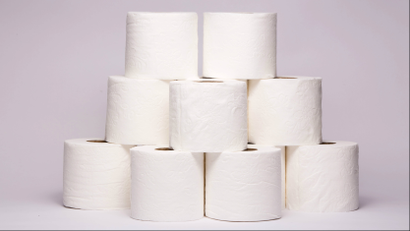 A stack of toilet paper against a neutral background.