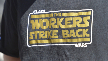 A t-shirt reads "Class Wars: The Workers Strike Back"