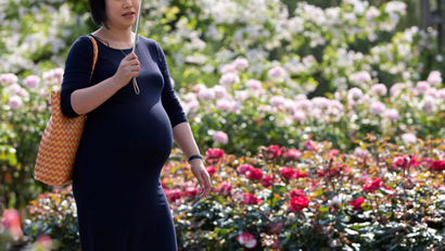 Pregnant woman in park.