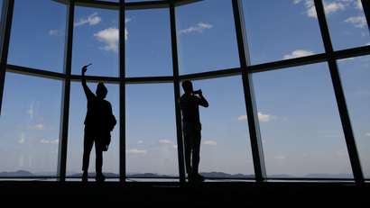 Visitors take a selfie at the Seoul Sky Observatory in Seoul, South Korea