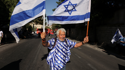 A man holds Israeli flags outside Jerusalem's Old City.