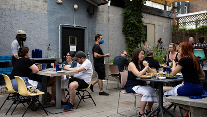 Customers drink and dine outdoors at the restaurant "Martha" in Philadelphia, Pennsylvania, U.S.