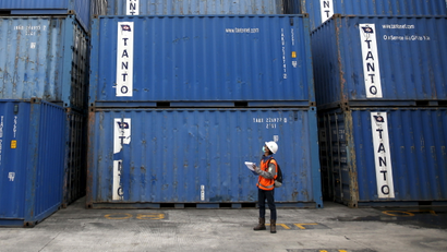 A worker tracks shipping containers in Tanjung Priok port in North Jakarta, Indonesia December 15, 2015. Indonesia's economy picked up speed in the fourth quarter but full-year growth was still the slowest since the global financial crisis as weak consumption, investment and exports took a toll on output. Picture Taken December 15, 2015.