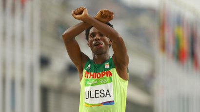 2016 Rio Olympics - Athletics - Final - Men's Marathon - Sambodromo - Rio de Janeiro, Brazil - 21/08/2016. Feyisa Lilesa (ETH) of Ethiopia celebrates.