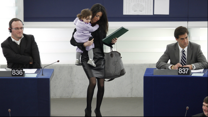 Italian Member of the European Parliament Ronzulli juggling her child, a bag and a folder