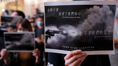 Anti-government protesters hold placards during a march in Causeway Bay in solidarity with the student protester who got shot by police with live ammunition in Hong Kong, China October 2, 2019.