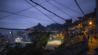 In this Oct. 21, 2014 photo, the upscale Ipanema neighborhood, left, stands along the coast, seen from the Cantagalo slum in Rio de Janeiro, Brazil. Polls have shown the poor overwhelmingly support President Dilma Rousseff, who is running for reelection, while the rich are massively behind opposition candidate Aecio Neves ahead of the Oct. 26 presidential run-off election. (AP Photo/Felipe Dana)