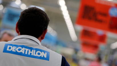 An employee works at the French sports equipment and sportswear company Decathlon store in Merignac near Bordeaux July 10, 2014. The group, number one in French distribution of sports equipment, with 730 stores worldwide, of which 262 are in France, focuses on the variety of its in-house brands to accelerate its growth and its expansion plans. Picture taken July 10, 2014. REUTERS/Regis Duvignau (FRANCE - Tags: BUSINESS) - PM1EA7B0S7T01