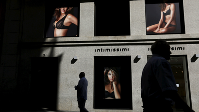 Men walk past a lingerie and underwear store in a shopping district in central Madrid