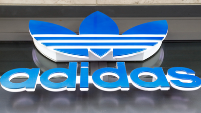 A photograph of an adidas store sign logo
