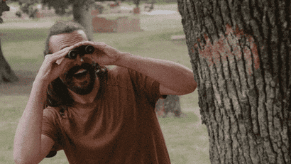 A gif from Queer Eye of Jonathan Van Ness holding binoculars.