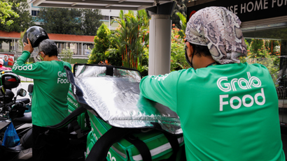 Food delivery riders get ready for a delivery outside a shopping mall, amid the coronavirus disease (COVID-19) outbreak in Singapore, May 26, 2020.