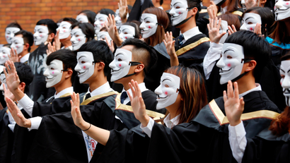 University students wearing Guy Fawkes masks pose for a photoshoot of a graduation ceremony to support anti-government protests at the Hong Kong Polytechnic University, in Hong Kong, China October 30, 2019.