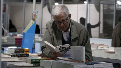 A man reads a book at the 32nd International Book Fair in Tunis, Tunisia, March 25, 2016.