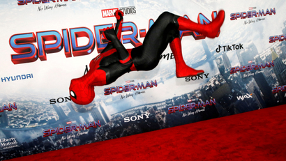 A person dressed in Spider-Man costume performs a flip on the red carpet at the movie premiere in Los Angeles.