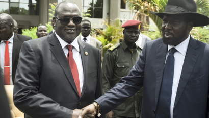 South Sudan's first vice president Riek Machar, left, and President Salva Kiir, right, shake hands following the first meeting of a new transitional coalition government, in the capital Juba, South Sudan, Apr. 29.