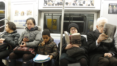 A schoolboy looks at his homework while riding the subway, Feb. 23, 2016 in New York. (AP Photo/Mark Lennihan)