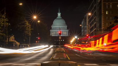 A red traffic light stands in front of the U.S. Capitol building in Washington