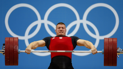 Poland's Tomasz Bernard Zielinski lifts on the men's 94Kg group B weightlifting competition at the ExCel venue at the London 2012 Olympic Games