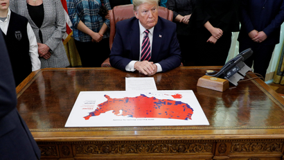 U.S. President Donald Trump looks over a 2016 U.S. Presidential Election map after delivering remarks at an event to announce new guidance on constitutional prayer in public schools inside the Oval Office at the White House in Washington, U.S., January 16, 2020