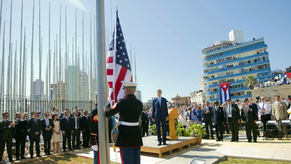 U.S. Secretary of State John Kerry (C) stands with other dignitaries as members of the U.S. Marines raise the U.S. flag over the newly reopened embassy in Havana, Cuba, August 14, 2015. Watched over by Kerry, U.S. Marines raised the American flag at the embassy in Cuba for the first time in 54 years on Friday, symbolically ushering in an era of renewed diplomatic relations between the two Cold War-era foes.