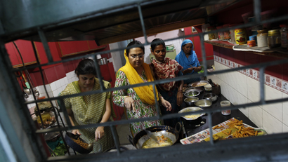 Muslim women prepare the Iftar meal during the holy month of Ramadan in Delhi