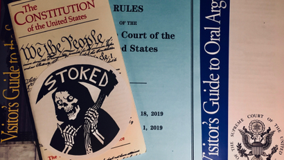 Constitution and SCOTUS guides with a sticker by cartoonist Becky Cloonan.