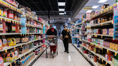 Shoppers browse in a supermarket while wearing masks to help slow the spread of coronavirus disease (COVID-19) in north St. Louis, Missouri, in April 2020.