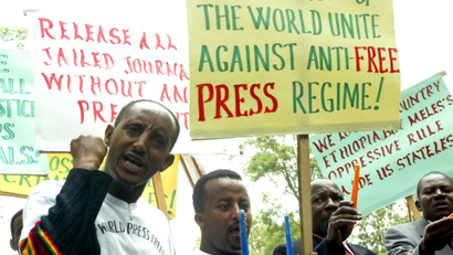 Ethiopian journalists hold placards as they shout slogans during a demonstration at the Ethiopian Embassy in Nairobi, Tuesday, May 2, 2006.