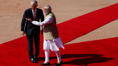 India's Prime Minister Modi gesutres as his Australian counterpar Turnbull watches during Turnbull's ceremonial reception at the forecourt of India's Rashtrapati Bhavan presidential palace in New Delhi