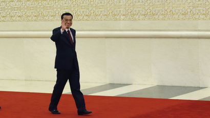 China's newly-elected Premier Li Keqiang (R) waves as he arrives for a news conference with newly-elected vice premiers Zhang Gaoli (C) and Liu Yandong after the closing session of the National People's Congress (NPC) at the Great Hall of the People in Beijing March 17, 2013. REUTERS/Kim Kyung-Hoon