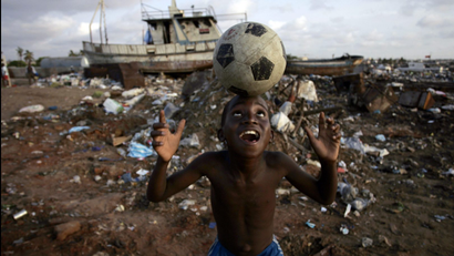 An Angolan youth plays soccer in the streets of the capital Luanda January 30, 2010.