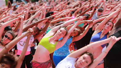 Attendees practice yoga at the Solstice in Times Square