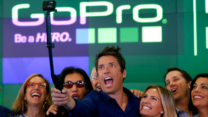 GoPro Inc's founder and CEO Nick Woodman (C) celebrates GoPro Inc's IPO with family and staff at the Nasdaq Market Site in New York City, June 26, 2014.