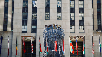 Iron throne replica in front of flags in NY.