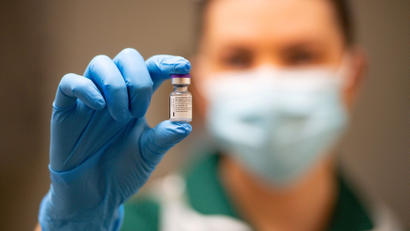 A person holds a vial of the Pfizer Covid-19 vaccine.