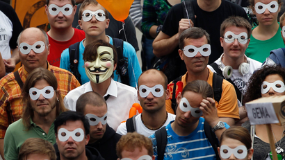 People wear masks during protest calling for protection of digital data privacy in Berlin