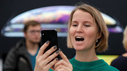 A customer reacts during the launch of the new iPhone XS and XS Max smartphones sales at "re:Store" Apple reseller shop in Moscow, Russia.